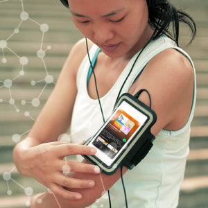 woman runner listening to music in headphones from smart phone